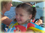 child with lifejacket in boat