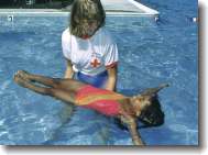 child swimming safely in pool